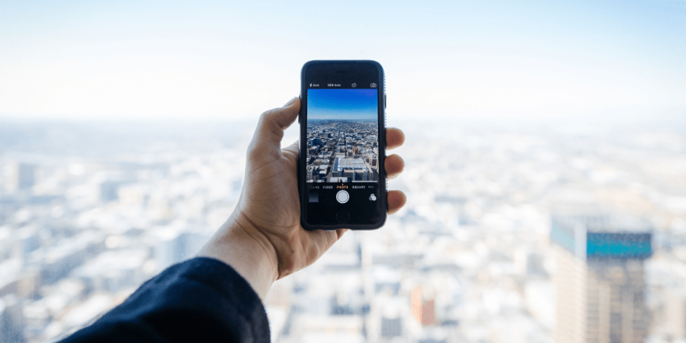 Stad fotograferen met smartphone vanaf hoog gebouw.